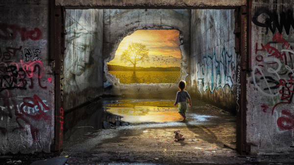 Child walking towards a vibrant sunset view.